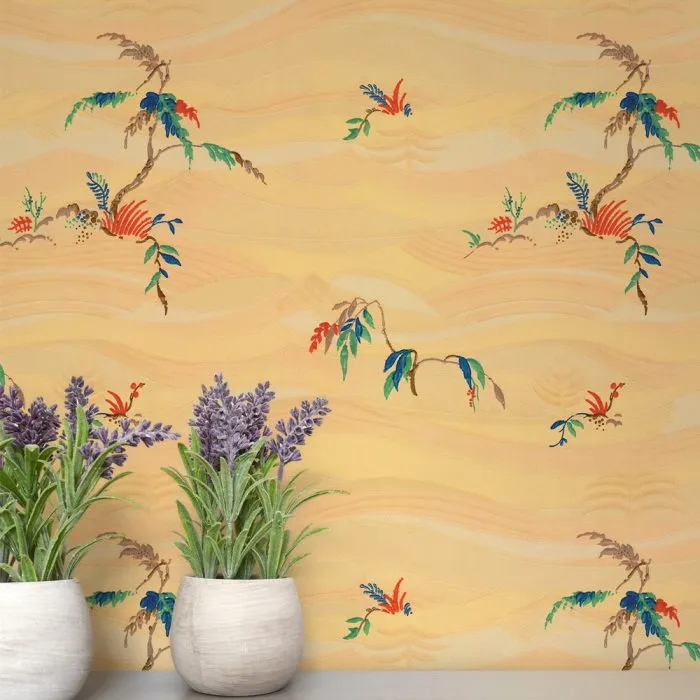 Two Windsong potted lavender plants sit in front of vintage wallpaper, its yellow background adorned with abstract, colorful floral and leaf designs—a perfect nod to classic set design.