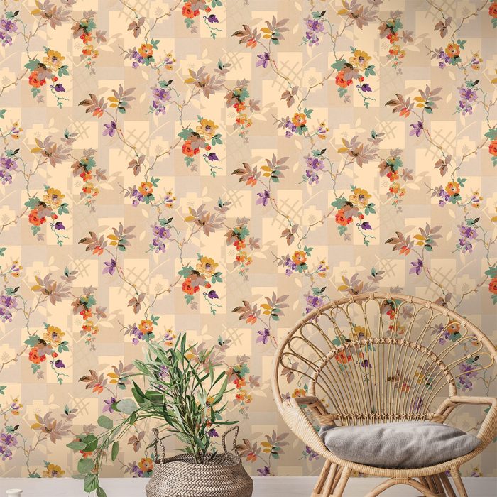 A beige wall featuring Patchwork Floral, a colorful art deco-inspired vintage wallpaper with floral and leafy patterns, paired with a wicker chair and potted plant—ideal for stylish set design.
